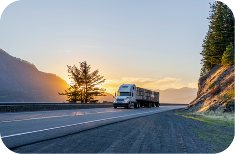 Semi-truck on open highway at sunrise representing Porter Freight Funding’s freight factoring solutions for trucking companies.